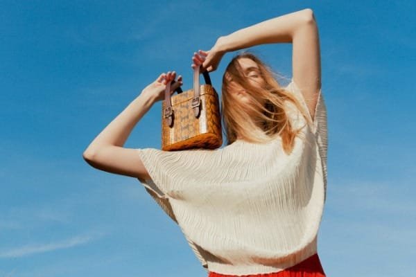 Officina Del Poggio's innovative leather handbag with modular compartments, shown in classic chestnut brown