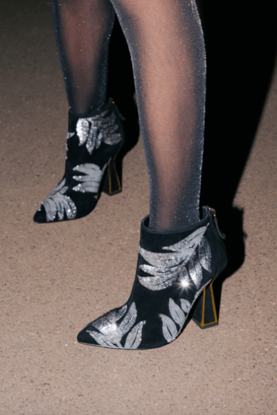 Kat Maconie black Lucie boots modeled Kat Maconie black Lucie boots with silver sequin leaf detail and gold-coloured metal heel detail.